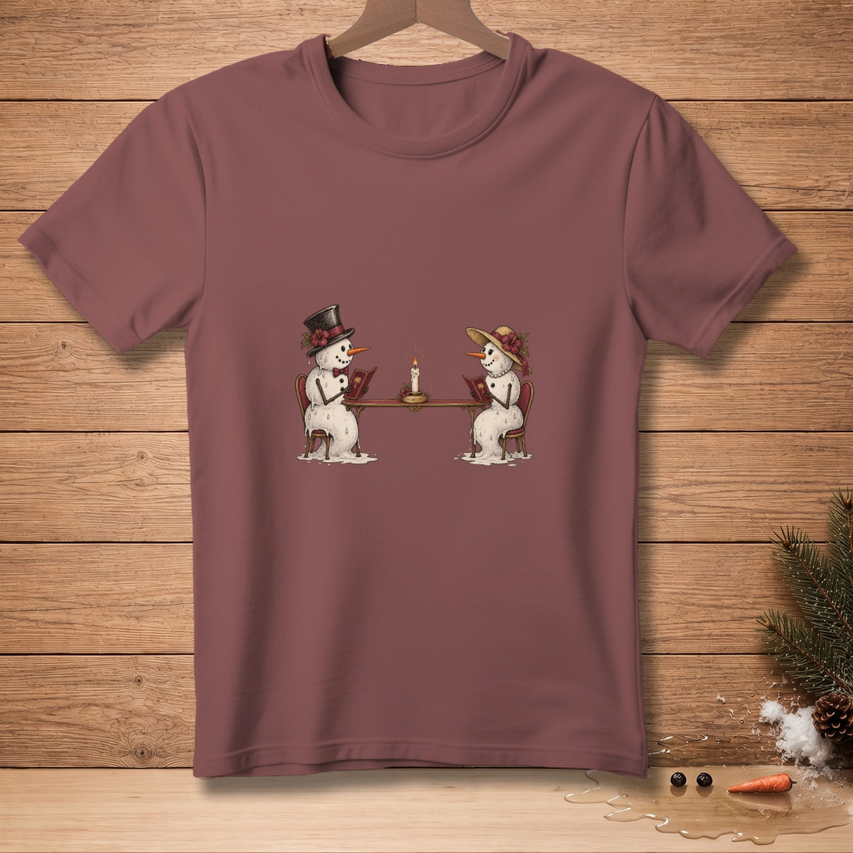 Two snowmen in hats sit at a table reading books next to a candle.
