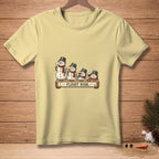 Light yellow t-shirt with snowmen holding wine glasses and the text "FLIGHT RISK."