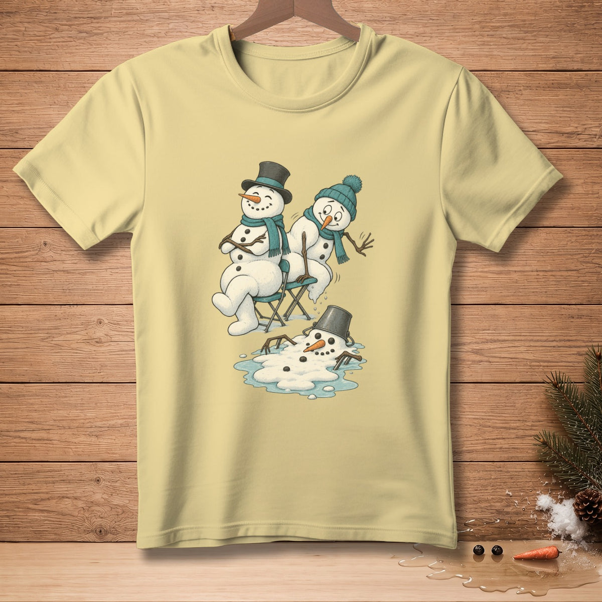 Light yellow t-shirt with cartoon of three melting snowmen, one upside down.