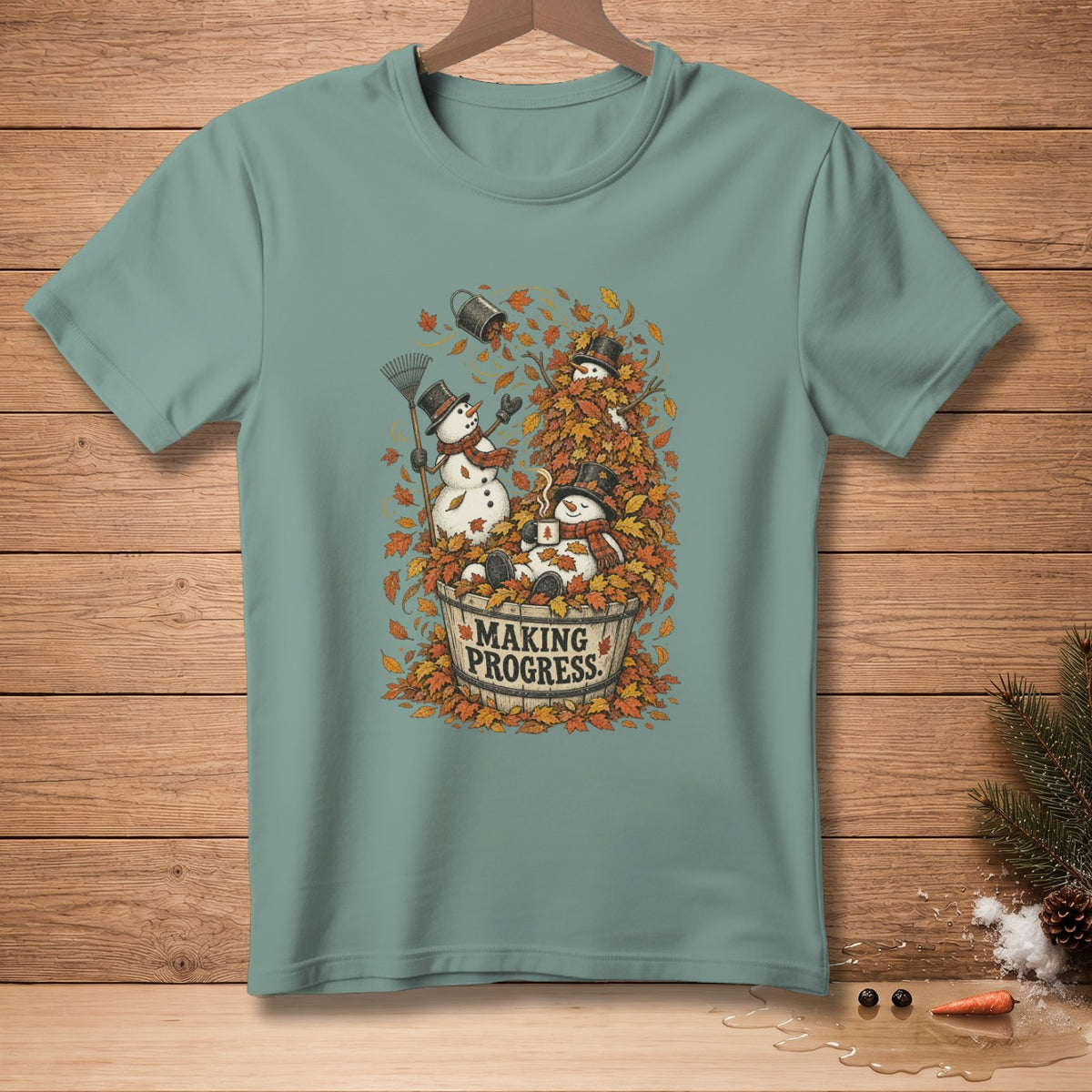 Snowmen in autumn leaves with a bucket and rake. Text reads "Making Progress."
