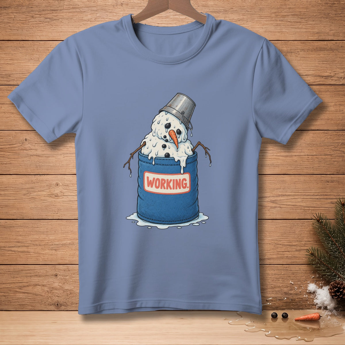 Melting snowman in bucket with "WORKING" text on a blue t-shirt.