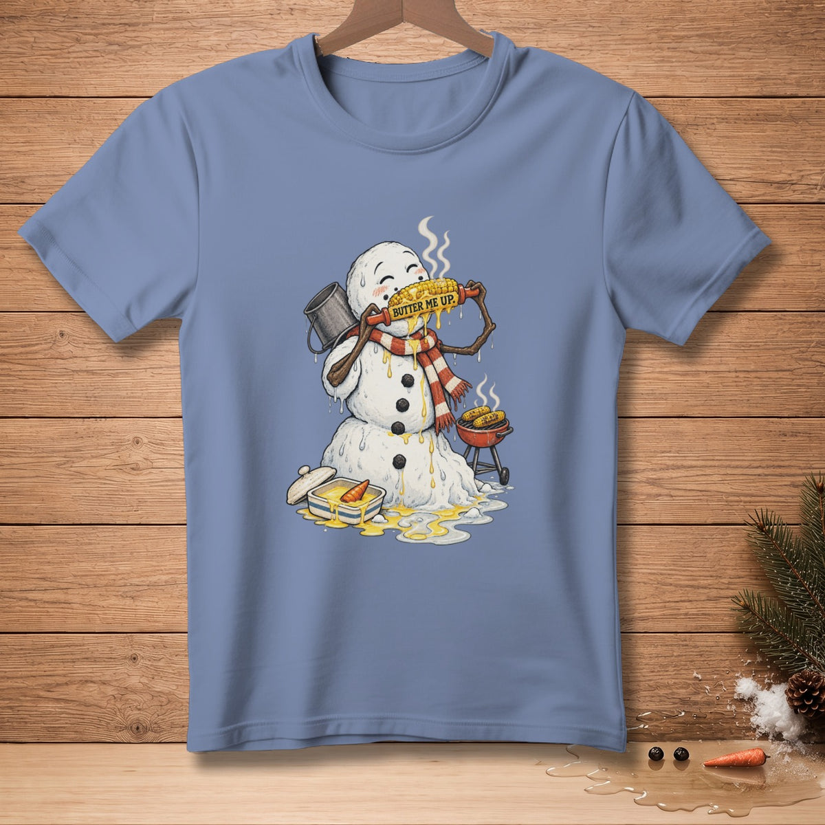 Snowman eating buttered corn on the cob with a grill and butter dish.