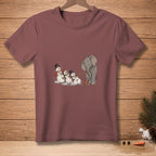 Elephant pulls snowmen by rope towards carrot on maroon t-shirt.