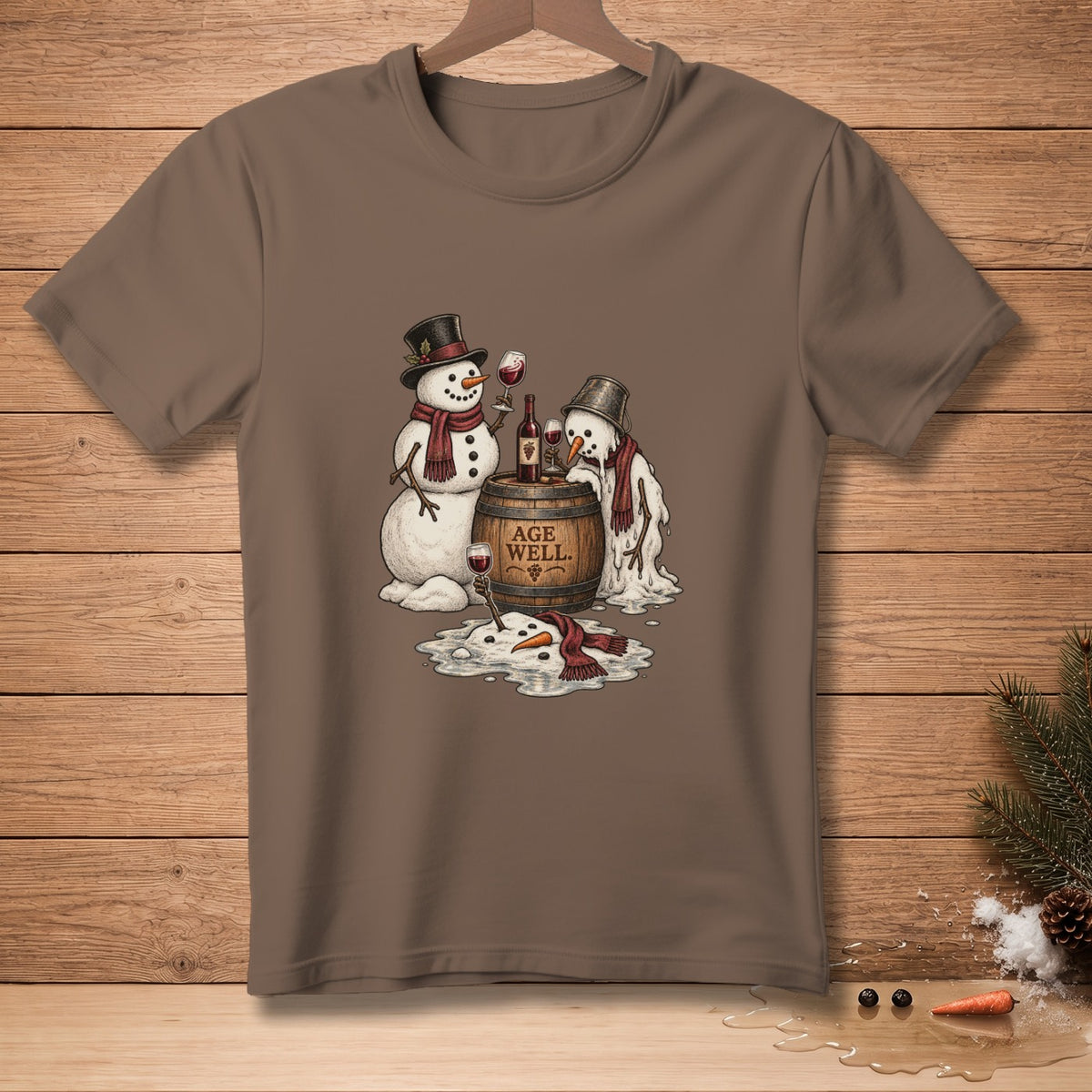 Two snowmen, one melting, enjoy wine from a barrel with "AGE WELL." text.