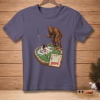 Bigfoot plays mini golf on a snowy course with a scorecard reading "Birdie".