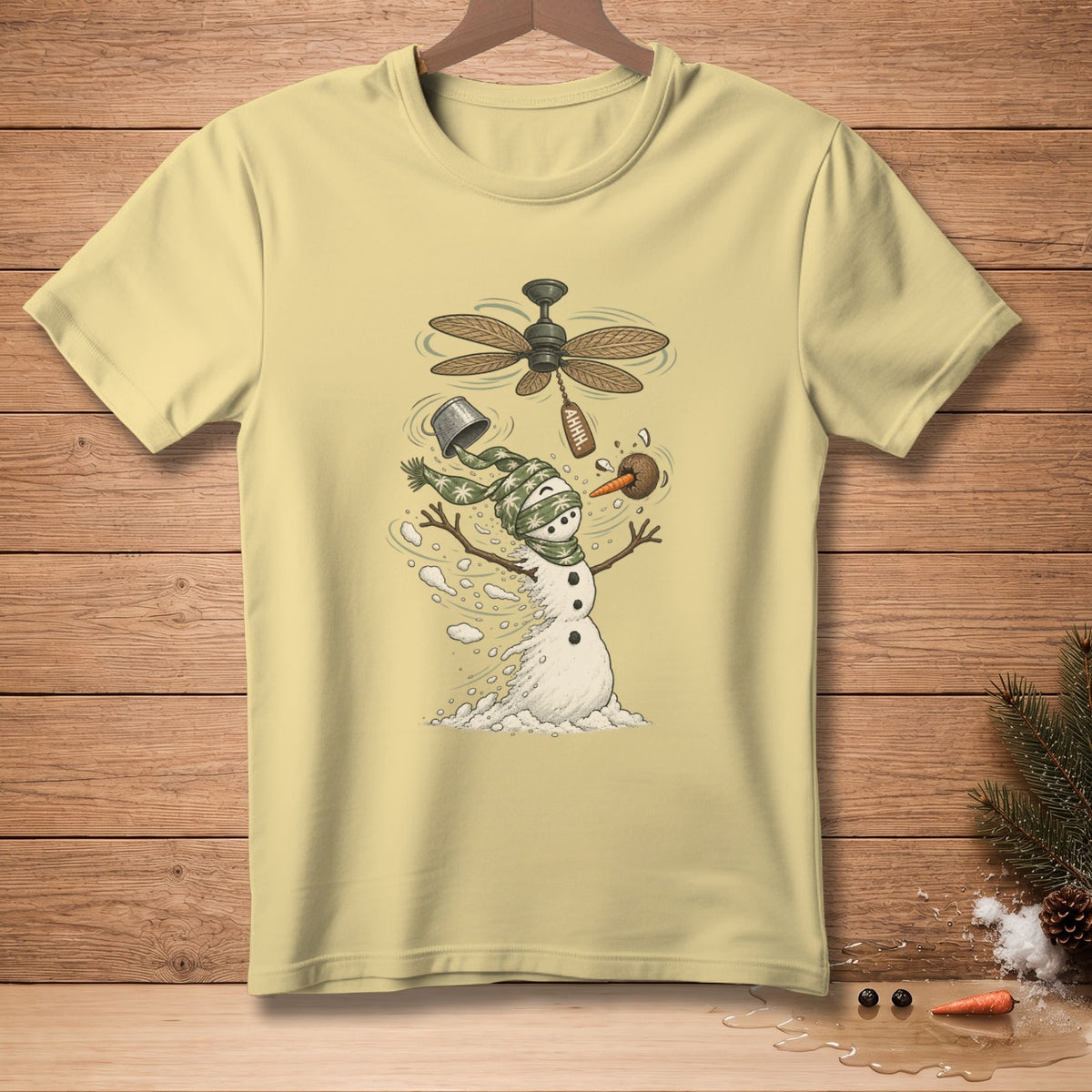 Pale yellow t-shirt with a distressed snowman graphic and a ceiling fan.