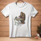 Bigfoot plays chess against a melting snowman with "Your Move" text on the table.