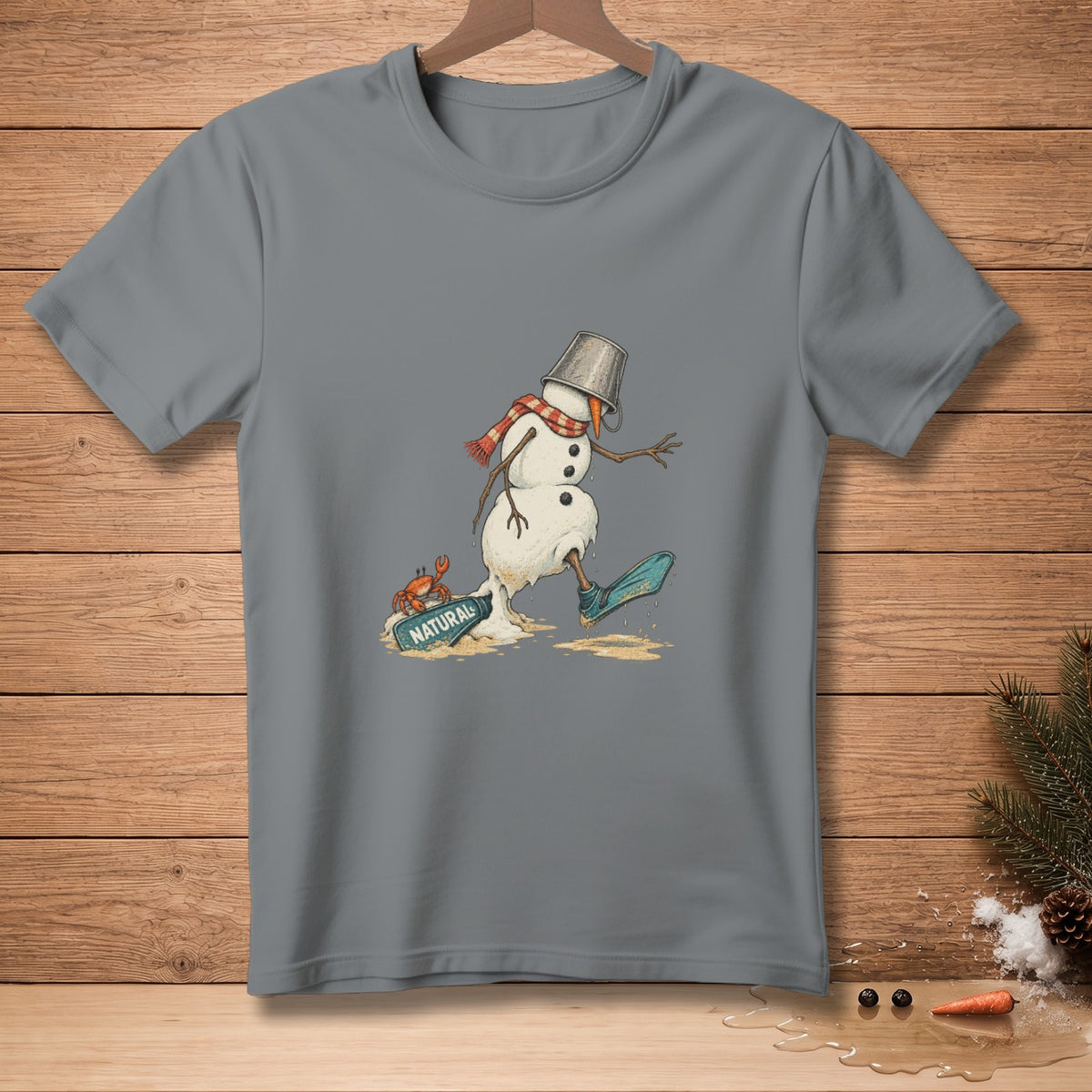 Melting snowman with bucket hat, scarf, boot, and crab on beach, text "NATURAL".