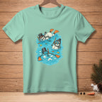 Three snowmen in snorkel gear swim with fish in blue water on a light teal shirt.