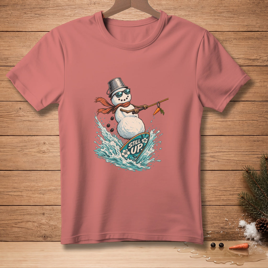 T-shirt with a graphic of a snowman surfing a surfboard with text "STILL UP".
