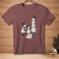 Three snowmen of varying sizes are depicted with hats and scarves, surrounding a drawing of a snowman.