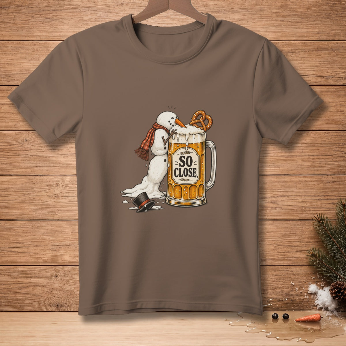 Snowman with scarf reaching for pretzel on beer mug with text "SO CLOSE".