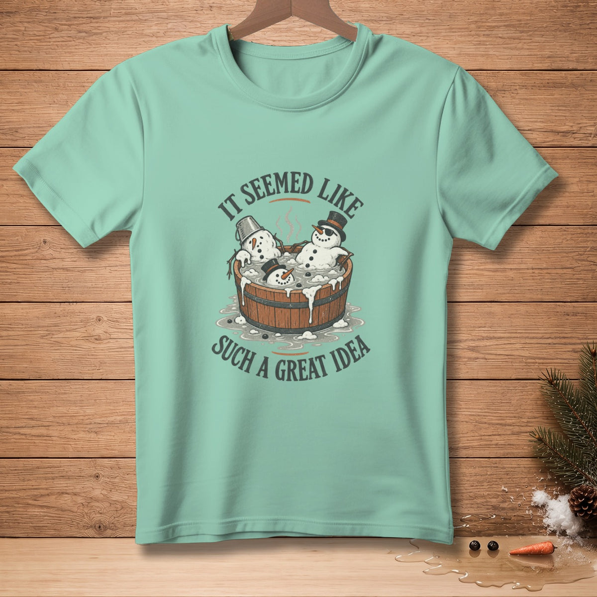 Green t-shirt with snowmen in a tub graphic: "It seemed like such a great idea."