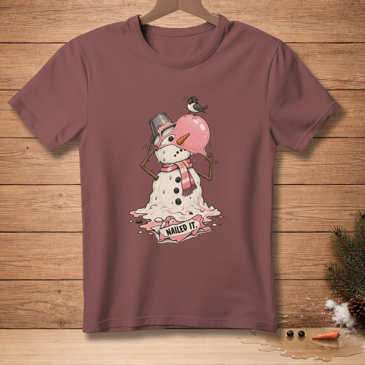 T-shirt with a melting snowman design that reads "NAILED IT."