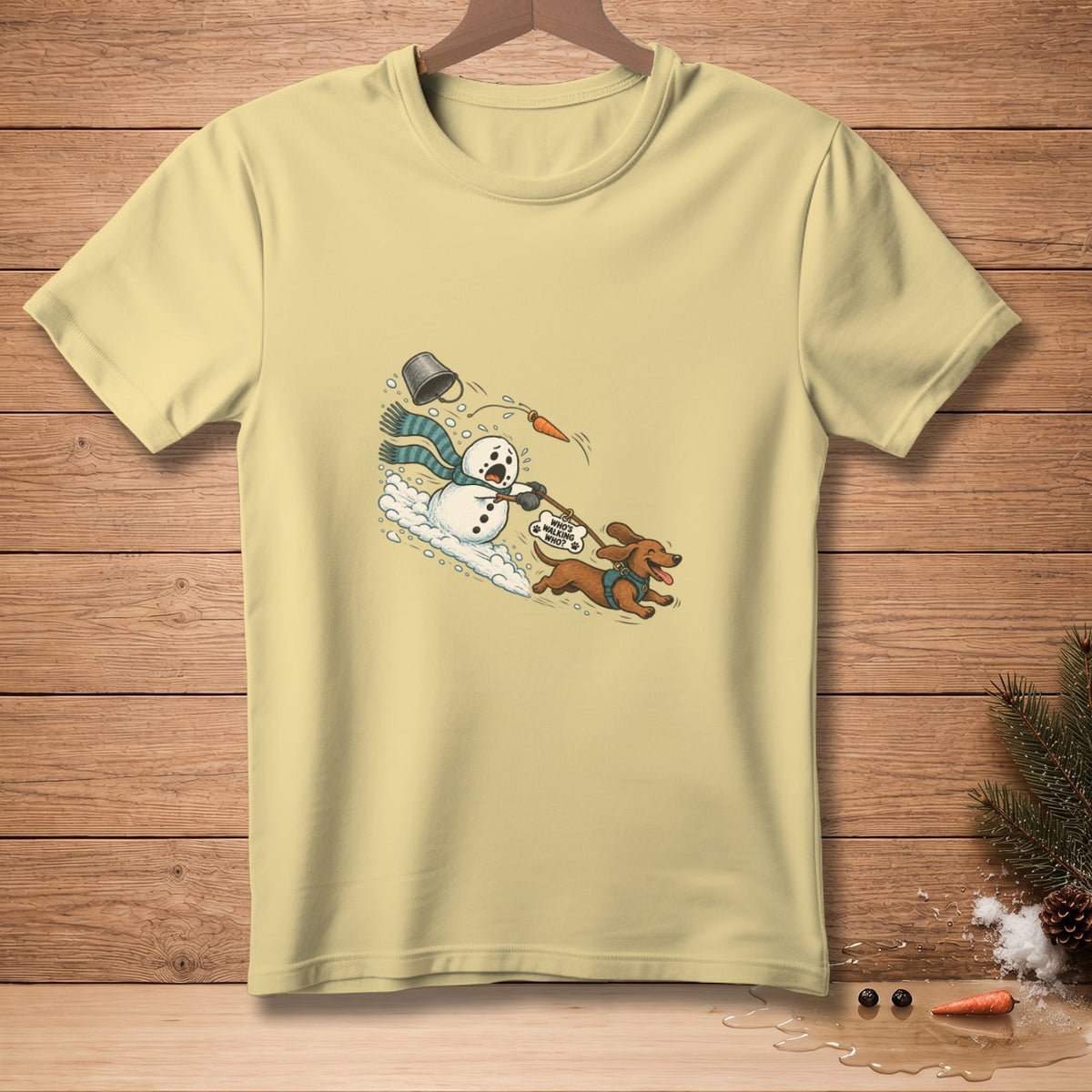 T-shirt with cartoon of snowman and dachshund, text "WHO'S WALKING WHO?"