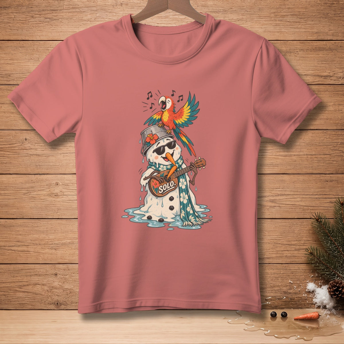 Snowman wearing sunglasses playing guitar with parrot on head, on pink t-shirt.