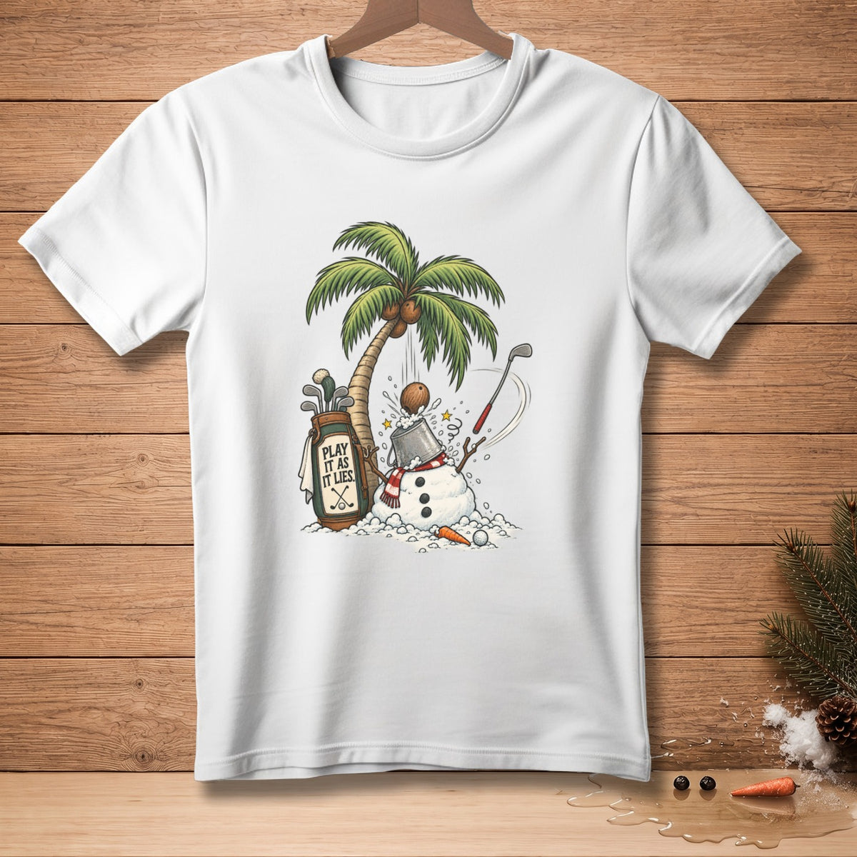 White t-shirt featuring a snowman, palm tree, coconut, golf bag, and clubs with text.