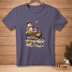 Two snowmen wearing hats and scarves cook a large breakfast with pancakes and bacon.