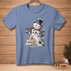 Snowman with top hat pouring milk into coffee mug that says "WORTH IT."