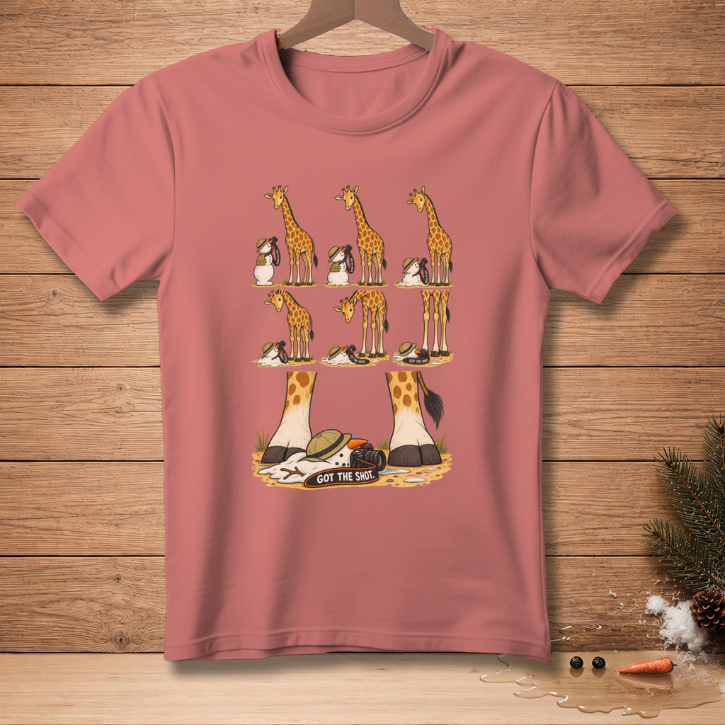 Giraffes and snowmen on a pink t-shirt, one snowman has a camera and reads "GOT THE SHOT."
