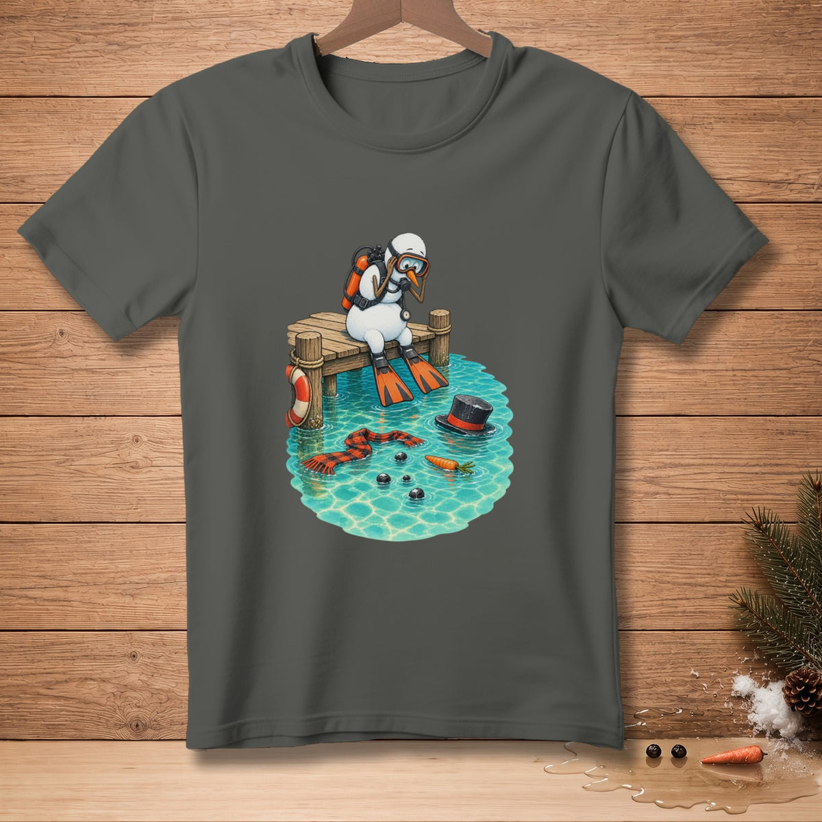 Snowman in scuba gear sits on a dock above water with scattered snowman parts.