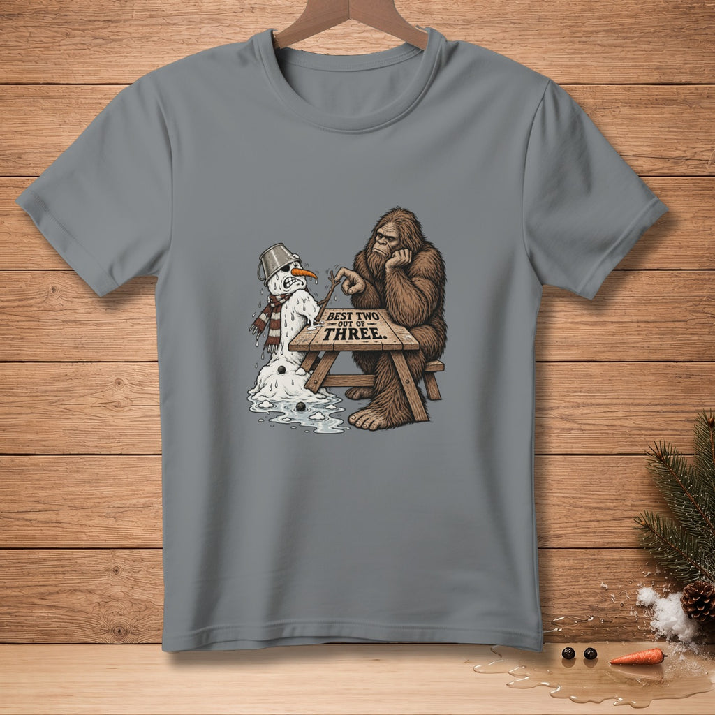 Bigfoot sits at a table with a melting snowman and text "BEST TWO OUT OF THREE".