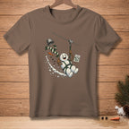Brown t-shirt featuring a cartoon snowman ziplining with a bucket, carrot, and a "Great Photo!" sign.