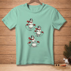 Mint t-shirt featuring three snowmen with red scarves jumping rope.