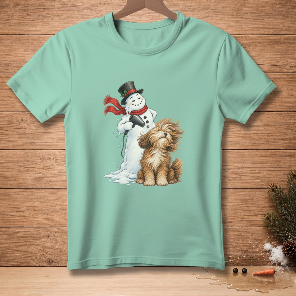 Melting snowman with hairdryer and shaggy dog graphic on a teal t-shirt.