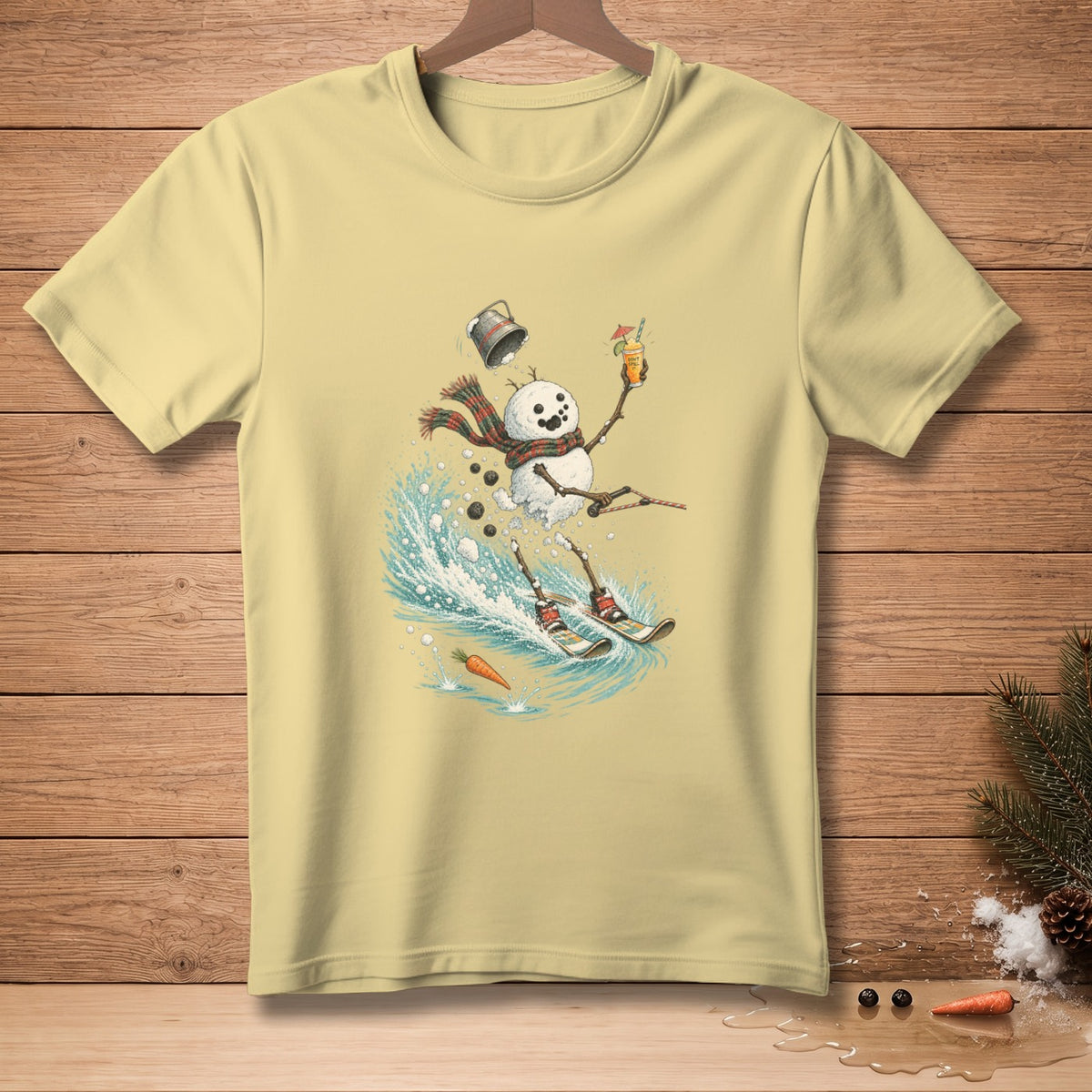 Snowman skiing with a drink and a bucket falling, on a light yellow t-shirt.
