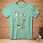 Melting snowmen play golf with flamingos on a mint green t-shirt.