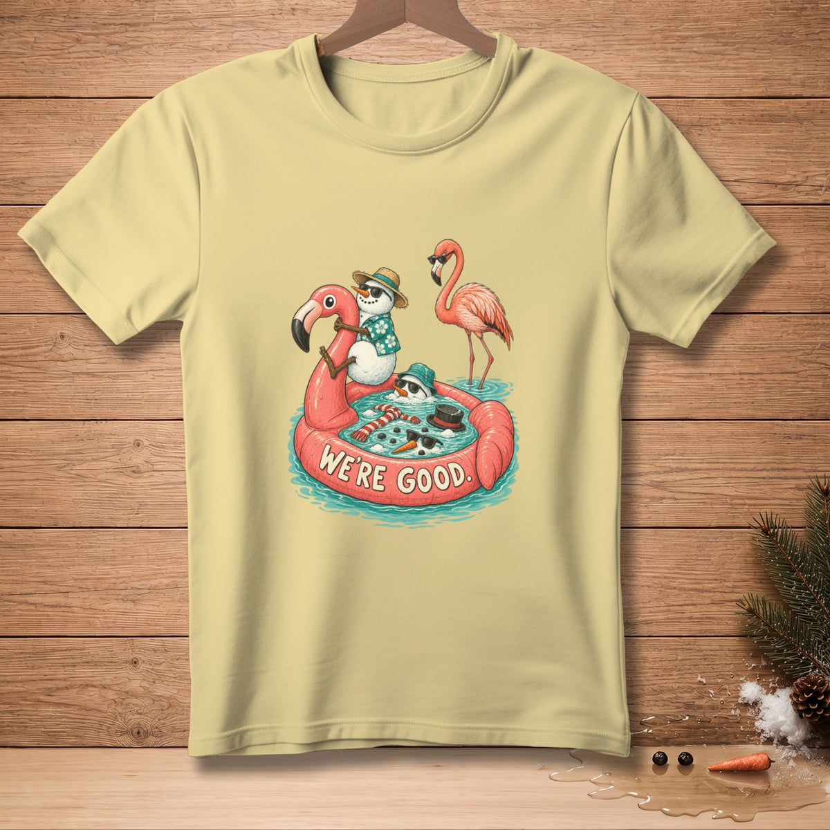 Snowmen and flamingo float on a pink flamingo pool float with "WE'RE GOOD." text.