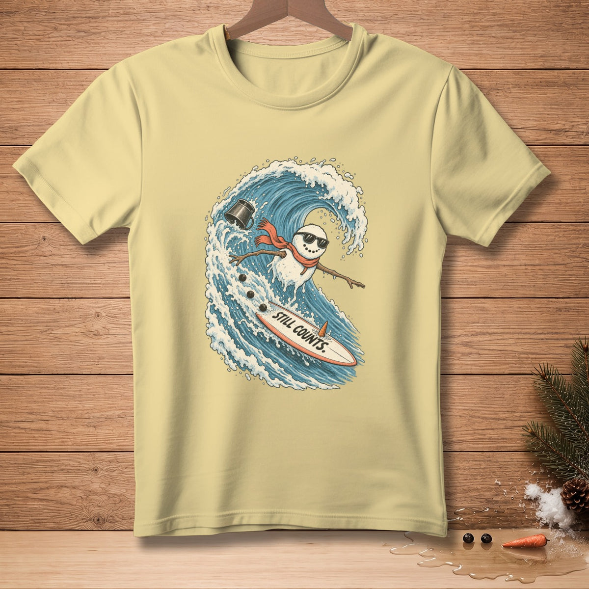 Snowman surfing a wave on a surfboard with text "STILL COUNTS".
