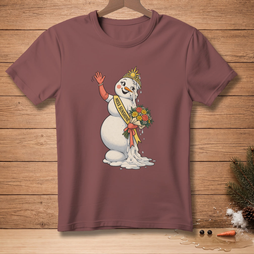 Melting snowman wearing crown and sash with "Miss Sunshine" text, holding flowers.