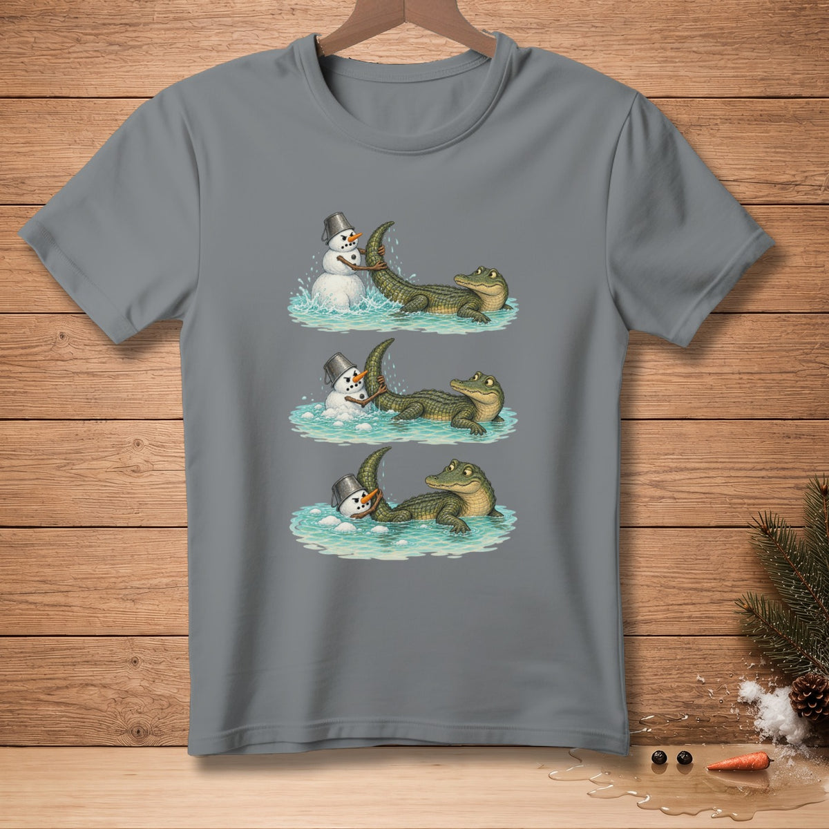 Grey t-shirt with a three-panel illustration of an alligator playing with a snowman.