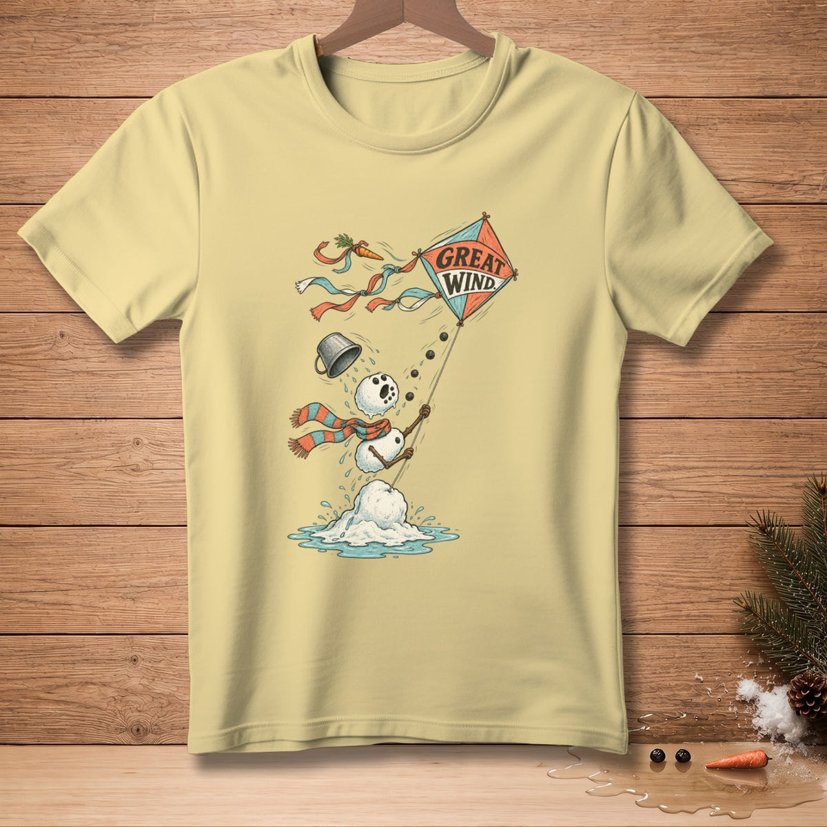 Light yellow t-shirt with melting snowman flying a kite that says "Great Wind."