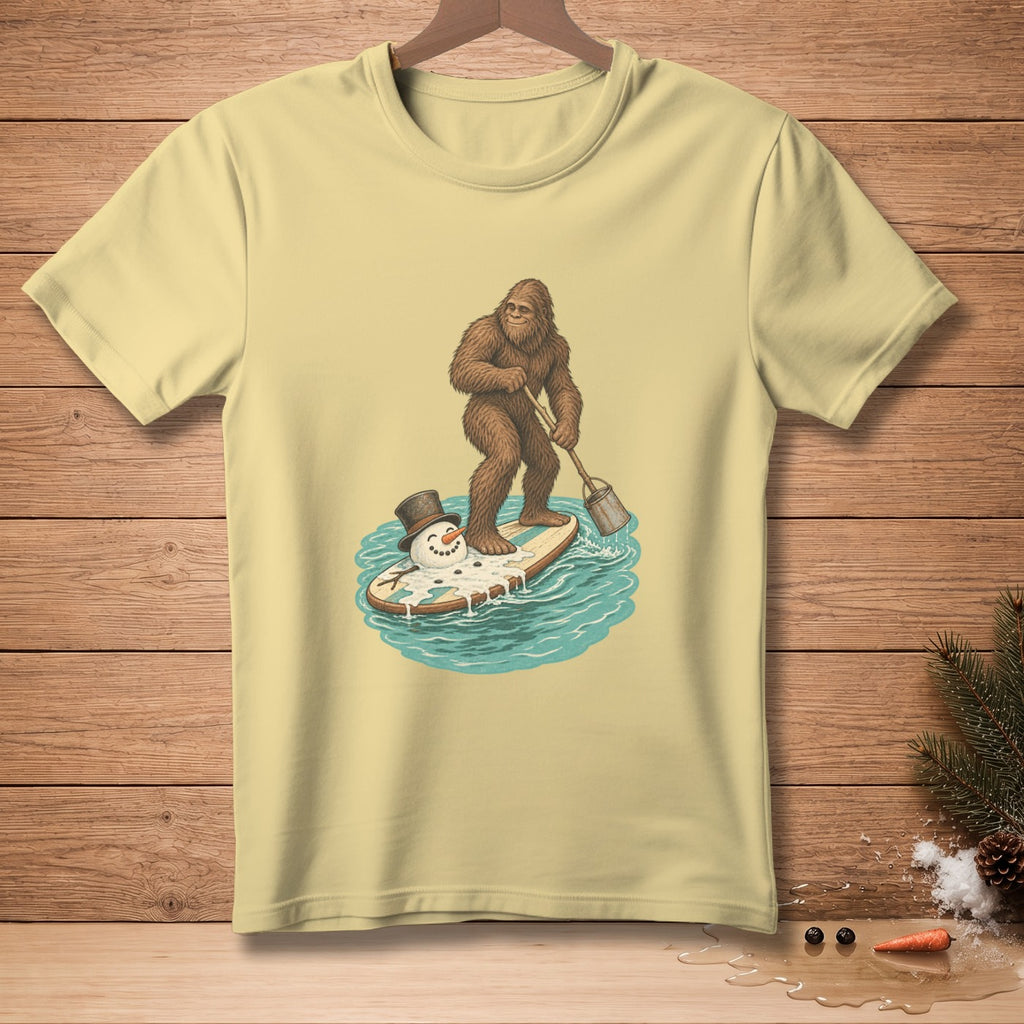 Bigfoot surfs on a melting snowman on a paddleboard.