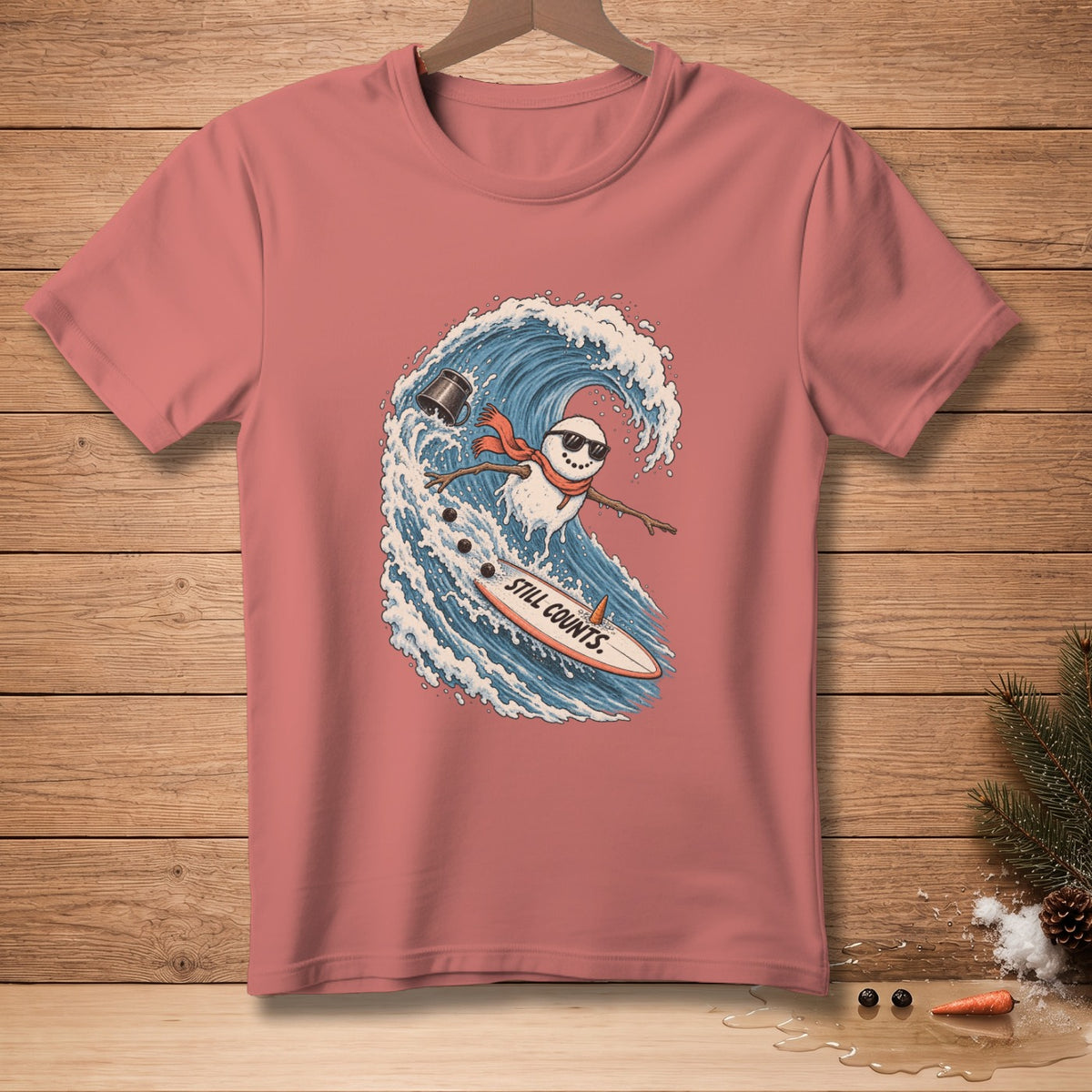 Snowman surfing a wave on a surfboard with text "Still Counts".