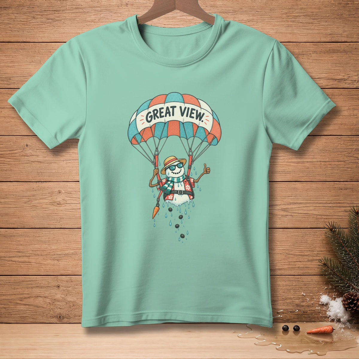 Mint t-shirt with a melting snowman in sunglasses parachuting with "GREAT VIEW" text.