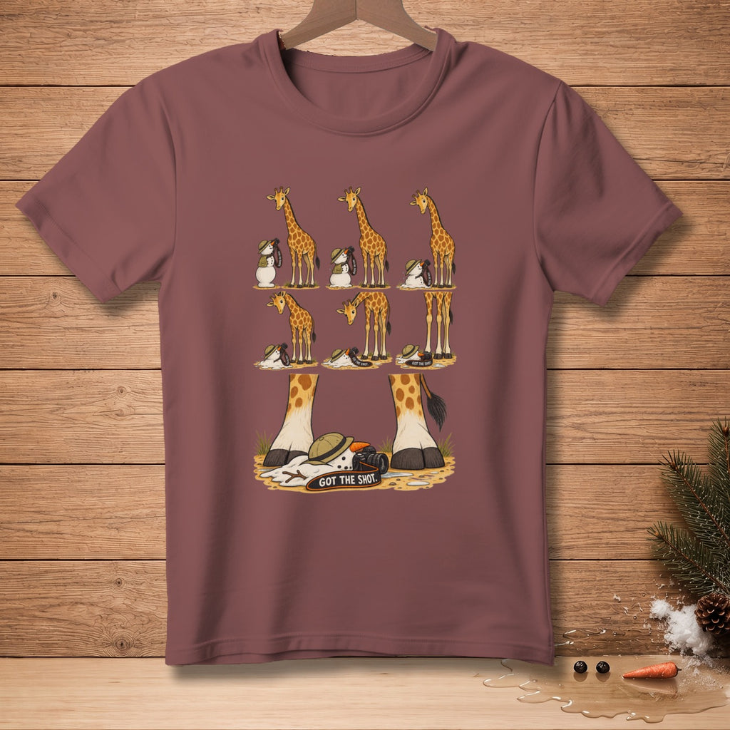 Giraffes and snowmen with cameras pose in a staged scene on a maroon t-shirt.
