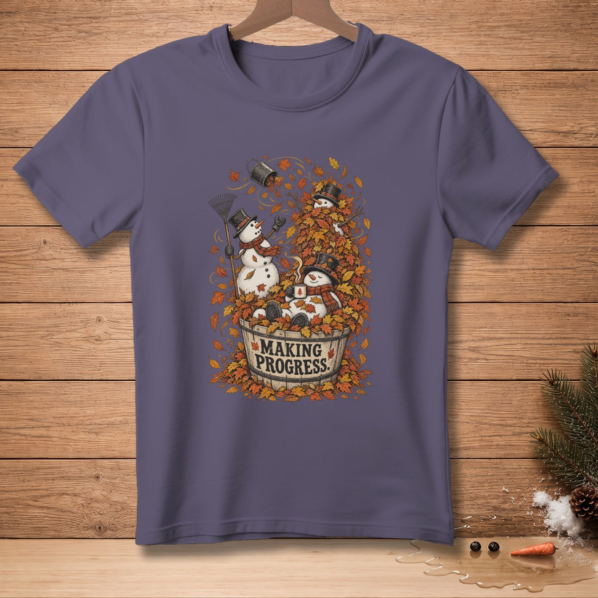 Snowmen in a barrel overflowing with autumn leaves with text "MAKING PROGRESS."