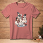 Snowmen building a snowman with "CLOSE ENOUGH" sign on pink t-shirt.