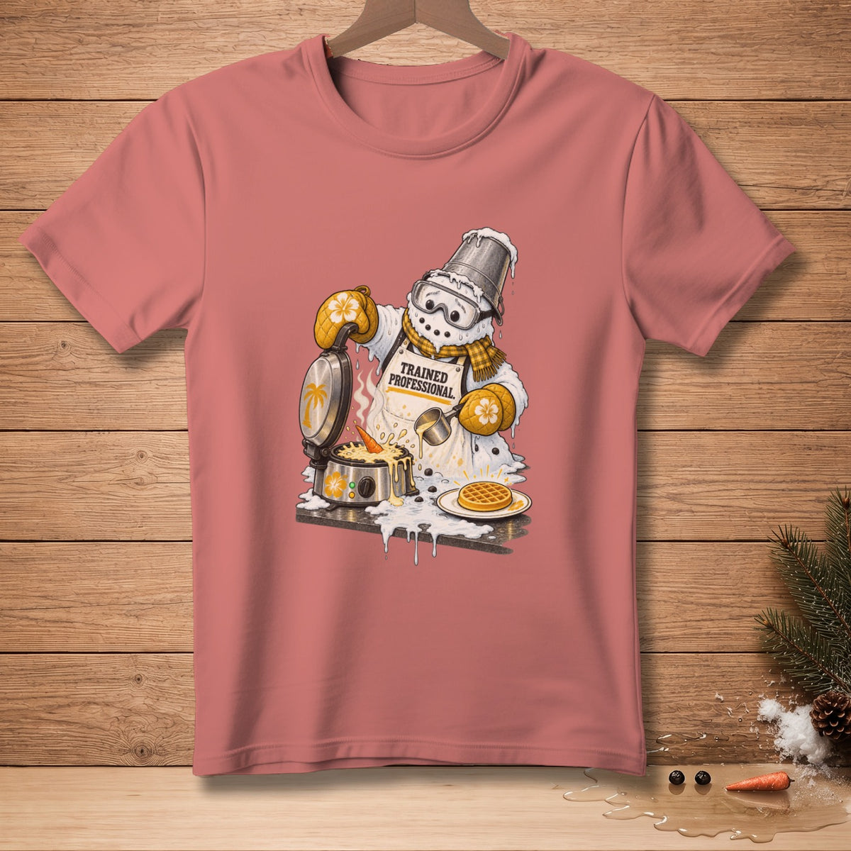 Snowman wearing apron "Trained Professional" making waffles on a waffle iron.