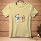 Golden retriever plays with a melting snowman, wearing a blue shirt with flowers.