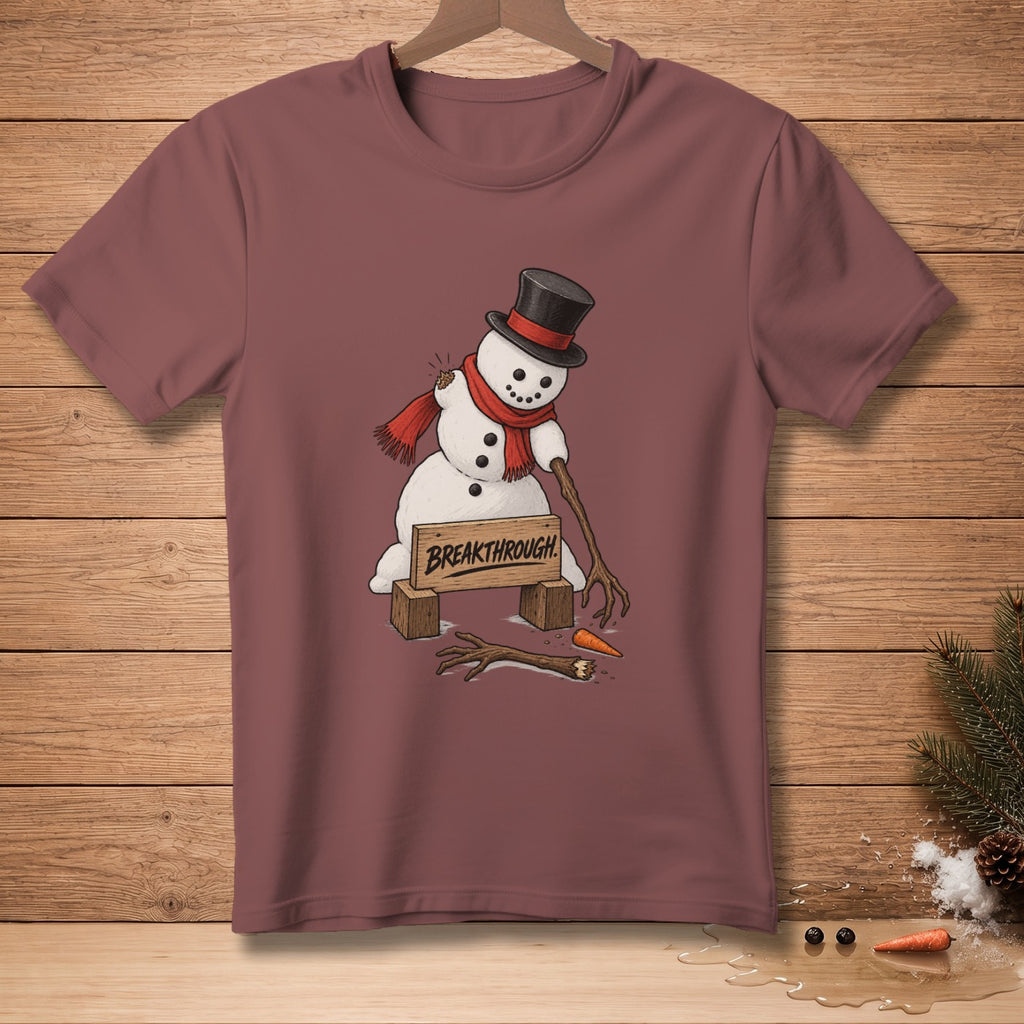 Snowman with broken arms and a carrot nose, wearing a top hat and scarf, with "BREAKTHROUGH" sign.