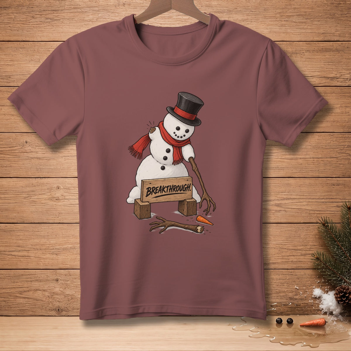 Snowman with broken arms and a carrot nose, wearing a top hat and scarf, with "BREAKTHROUGH" sign.