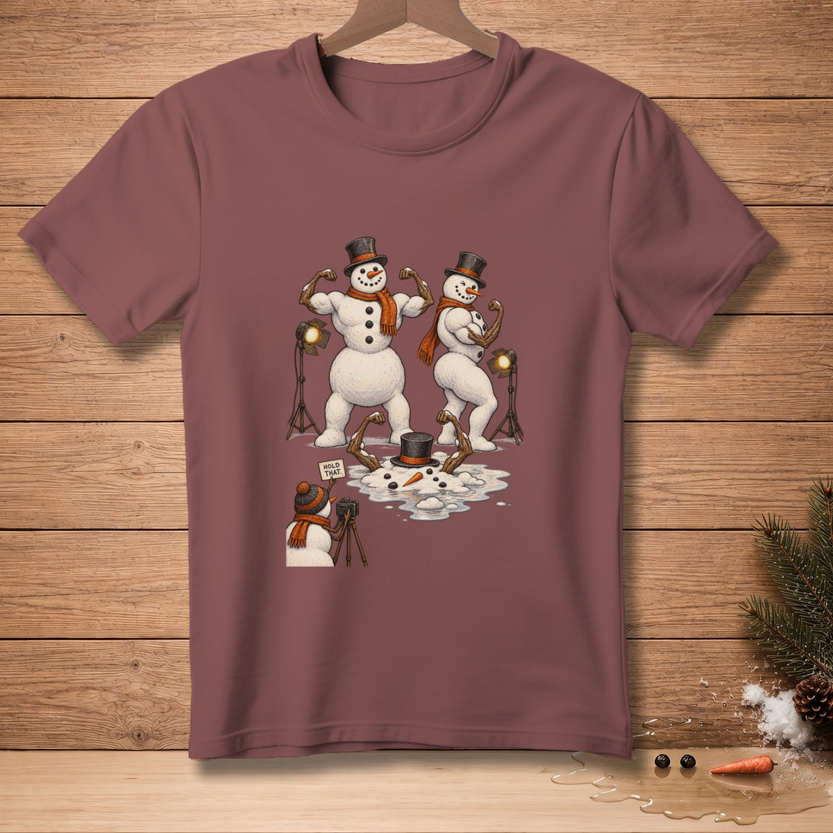 Two buff snowmen pose for a photographer snowman with a "Hold That" sign.