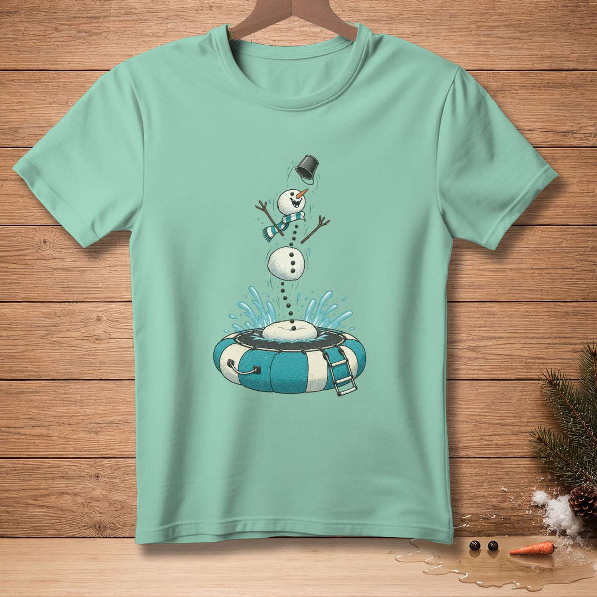 Mint t-shirt with illustration of a snowman falling into an inner tube with water splashing.