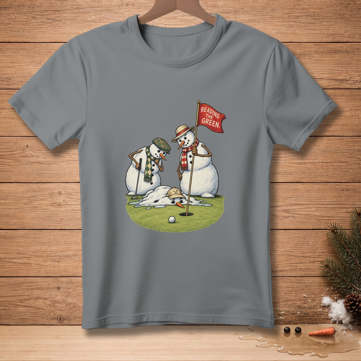 Two snowmen on a golf course with a melting snowman and a flag that reads "Reading The Green."