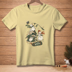 Light yellow t-shirt featuring cartoon snowmen camping with a rolled sleeping bag.